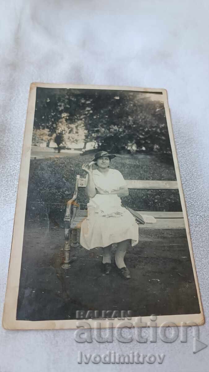 Photograph Vidin. Young woman sitting on a bench in the City Garden