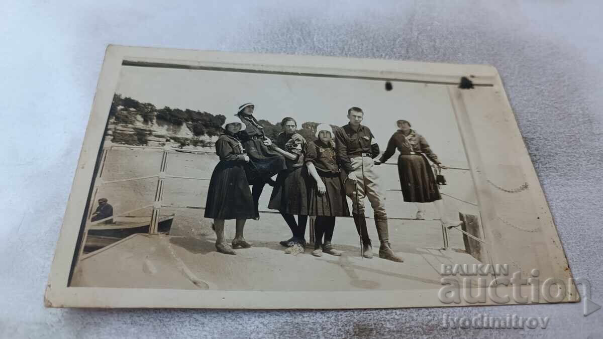 Photo of a Young Man and Five Young Girls on the Pier Photo of a Young Man and Five Young Girls on the Pier