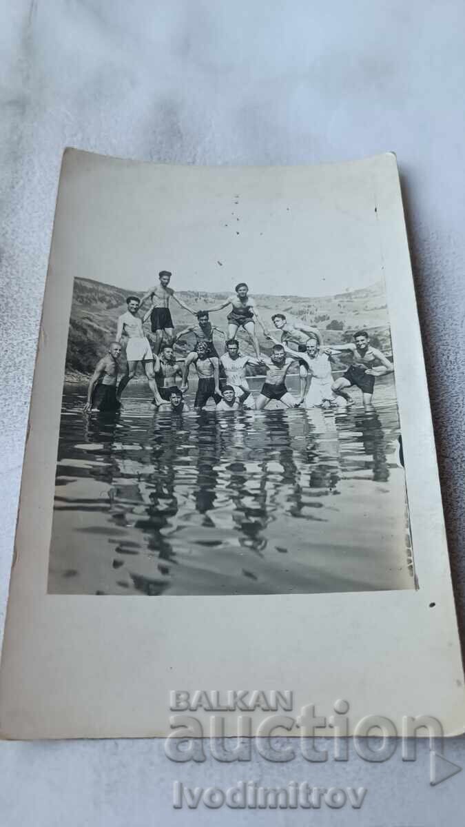 Photo of Young Men Making a Pyramid in the River Photo of Young Men Making a Pyramid in the River
