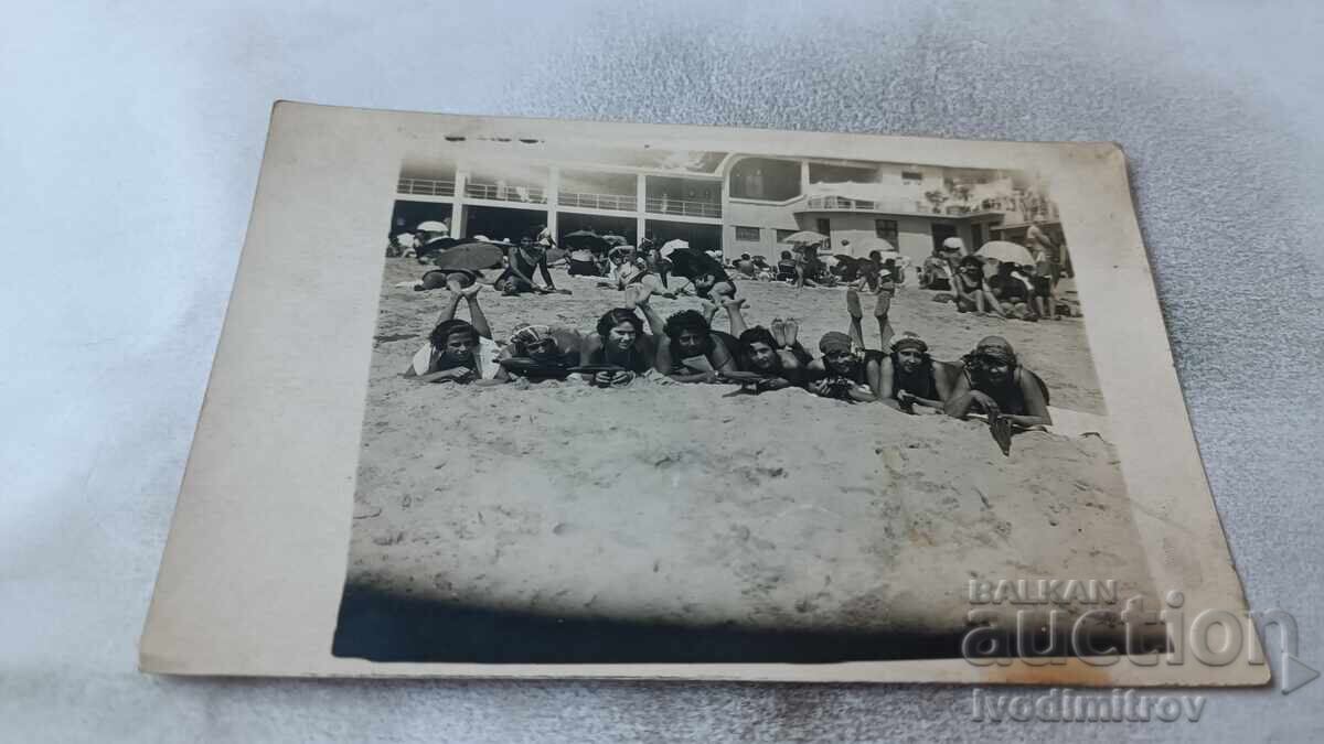 Photo of Young Girls in Retro Swimsuits Lying on the Beach