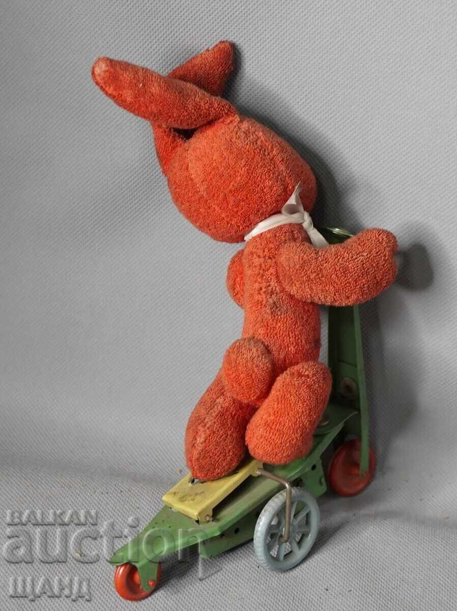 Delivery of Old mechanical metal toy scooter model with rabbit Delivery of Old mechanical metal toy scooter model with rabbit