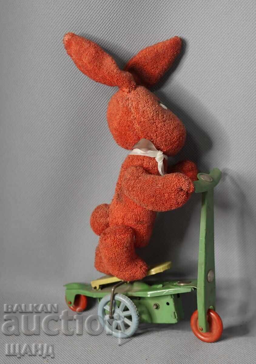 Old mechanical metal toy scooter model with rabbit Old mechanical metal toy scooter model with rabbit