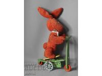 Old mechanical metal toy scooter model with rabbit