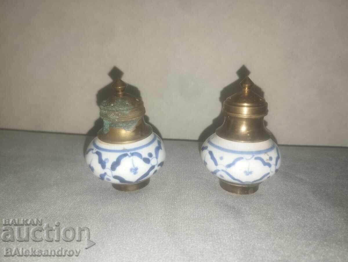 Two porcelain salt shakers with brass ornaments