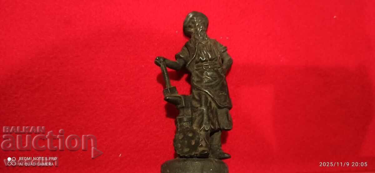 Old bronze miniature of a blacksmith, very beautiful and delicate