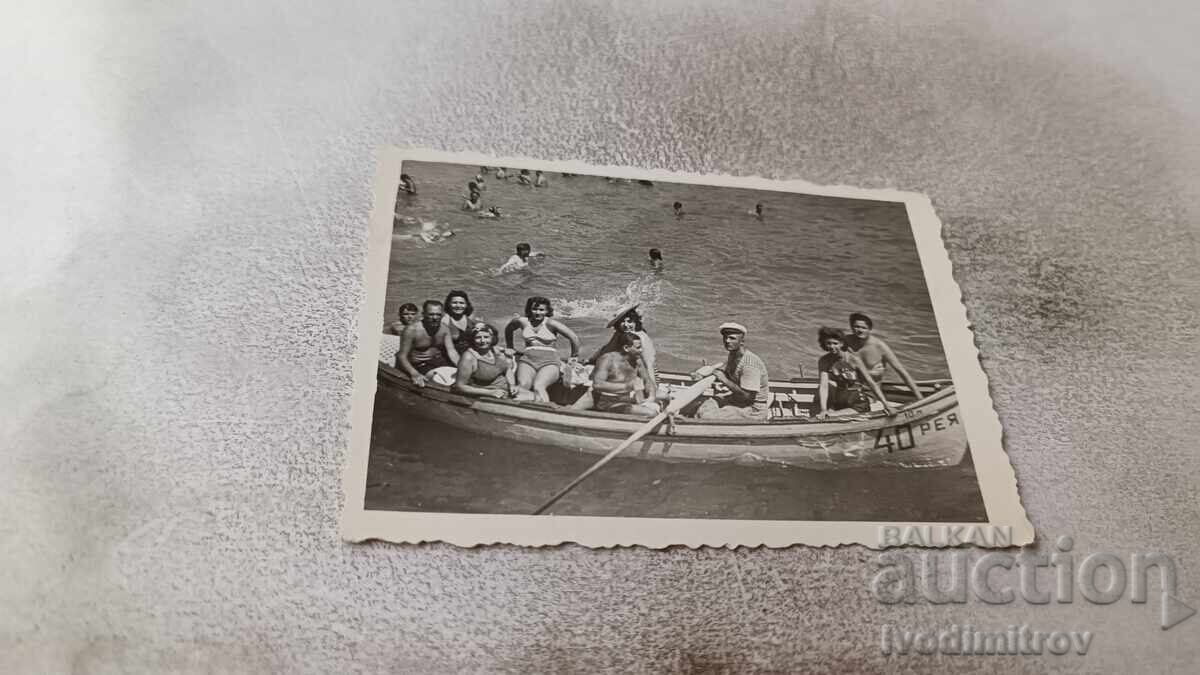 Photo of Men and Women in a Pleasure Boat on the Sea REA