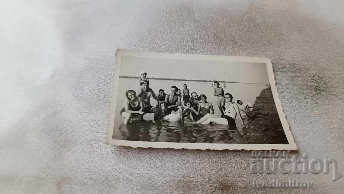 Photo of Men, Boys, and Girls on the Beach