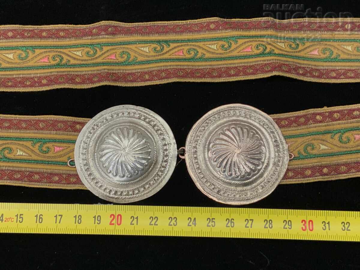 Revival-era silver paftas (ornamental belt buckles) and a belt with goldwork embroidery and textile Revival-era silver paftas (ornamental belt buckles) and a belt with goldwork embroidery and textile
