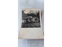 Photograph Men and women near beehives