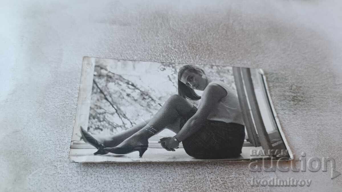 Photo of a Young Girl Sitting at the Window