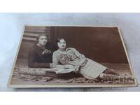 Photo: Two Young Girls Lying on the Floor