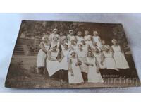 Photo of Young Girls in White Aprons