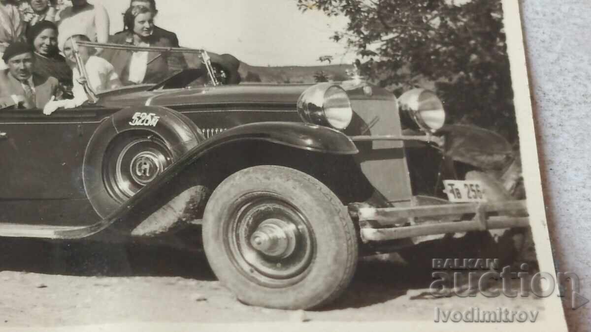 Auction  Photo of men and women with a retro car with license plate TV 256