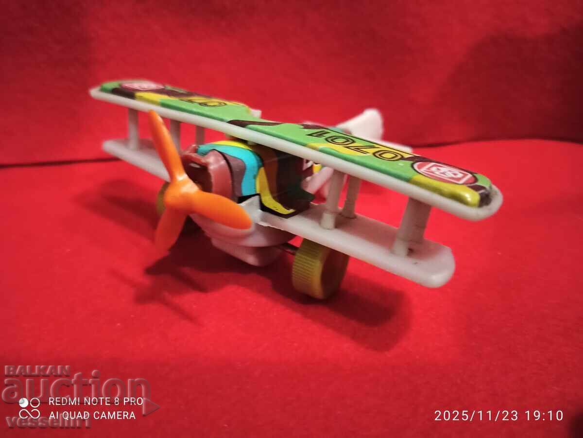 Old toy airplane, small airplane with an inertial mechanism Old toy airplane, small airplane with an inertial mechanism
