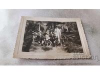 Photo of Lujene: Men, women, and children on a picnic in the forest
