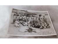 Photo of a man, woman, boys, and girls on the seashore