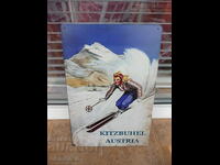 Metal sign various skis Kitzbühel Austria center winter resort