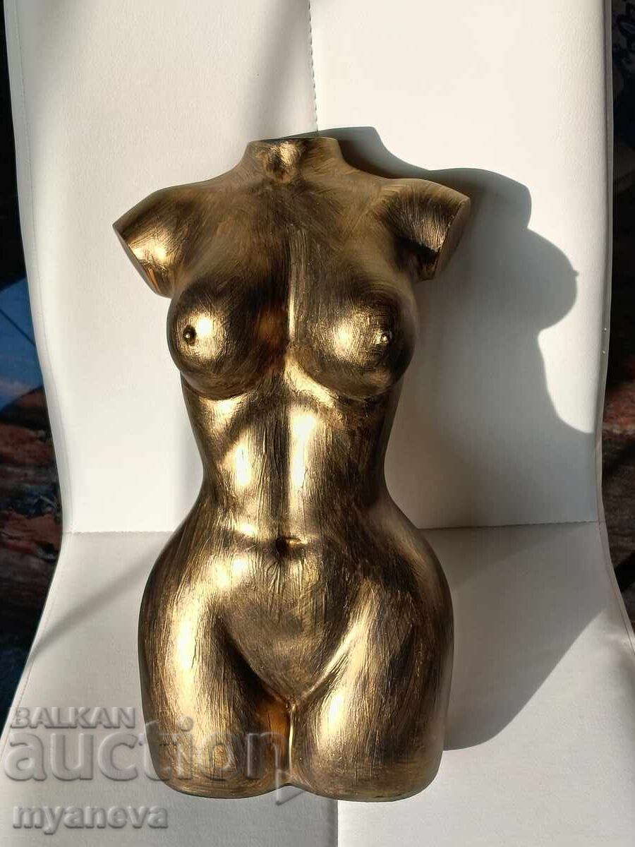 Sculpture of a female torso in an elegant golden color