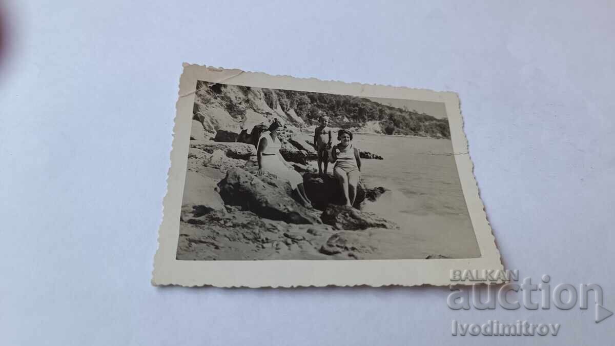 Photo of Two Young Women and a Little Boy by the Sea