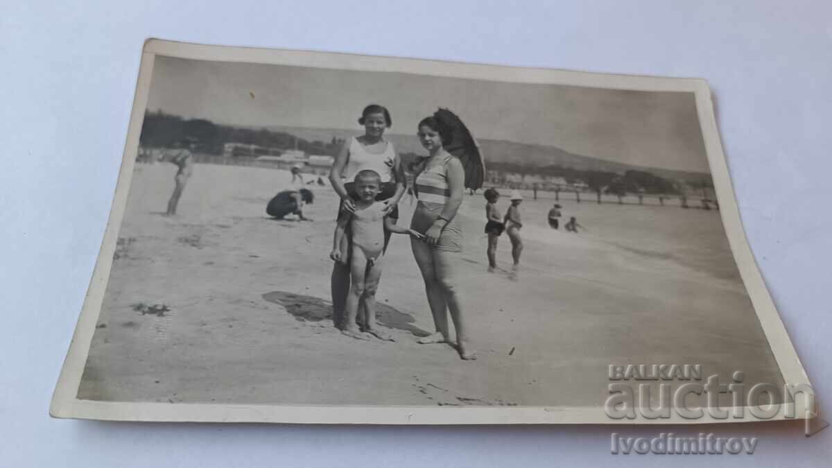Photo Varna Two young women and a little boy on the beach Photo Varna Two young women and a little boy on the beach