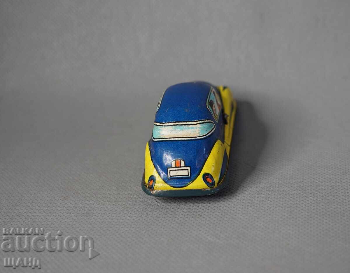 Delivery of Old metal mechanical toy car model for a racetrack Delivery of Old metal mechanical toy car model for a racetrack