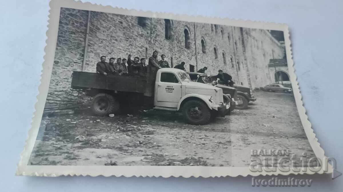 Photo Men with training trucks in front of Rila Monastery Photo Men with training trucks in front of Rila Monastery
