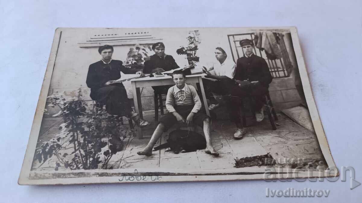 Photograph Lovech Youths and a boy with a black dog at a table 1932