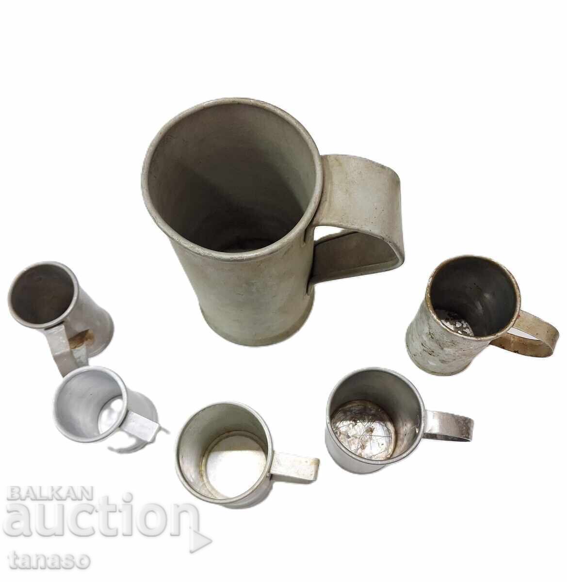 Auction  Old metal liquid measures