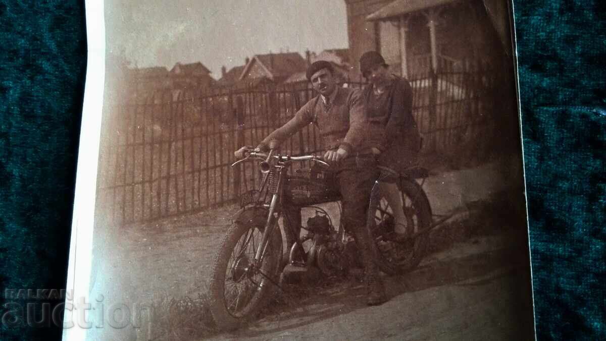 Delivery of Old photo. Boys on an old motorcycle