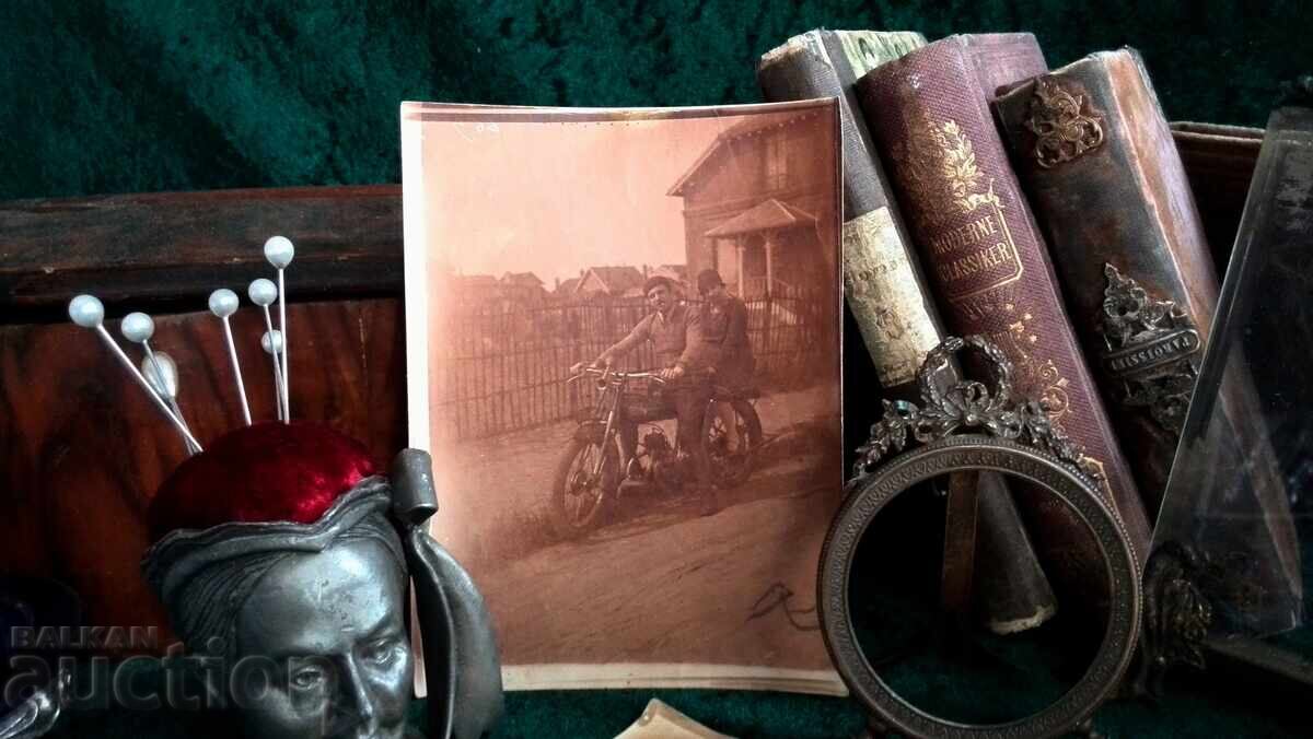 Old photo. Boys on an old motorcycle