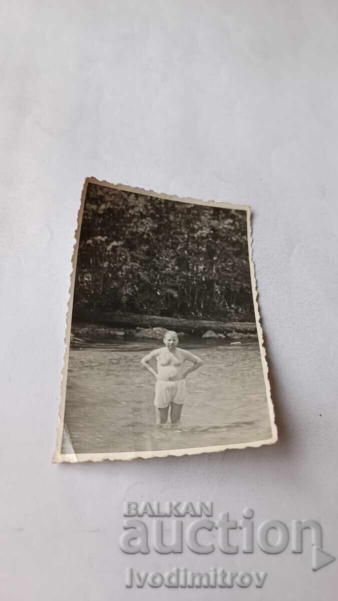 Photo of a Man in the River