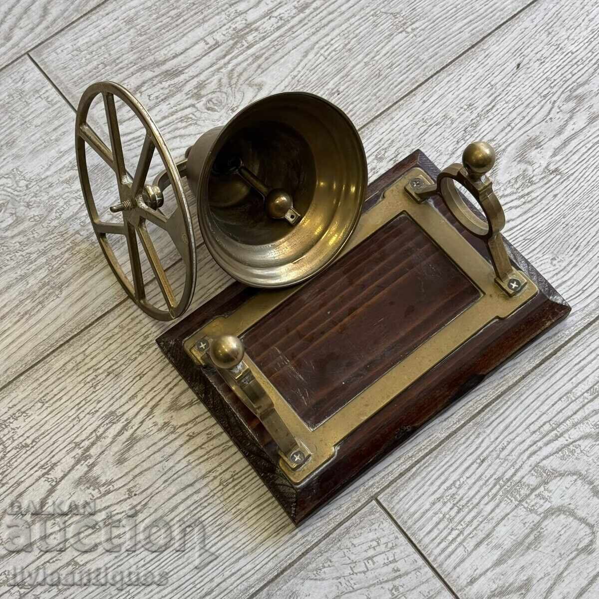 Auction  Brass bell on a solid wooden base