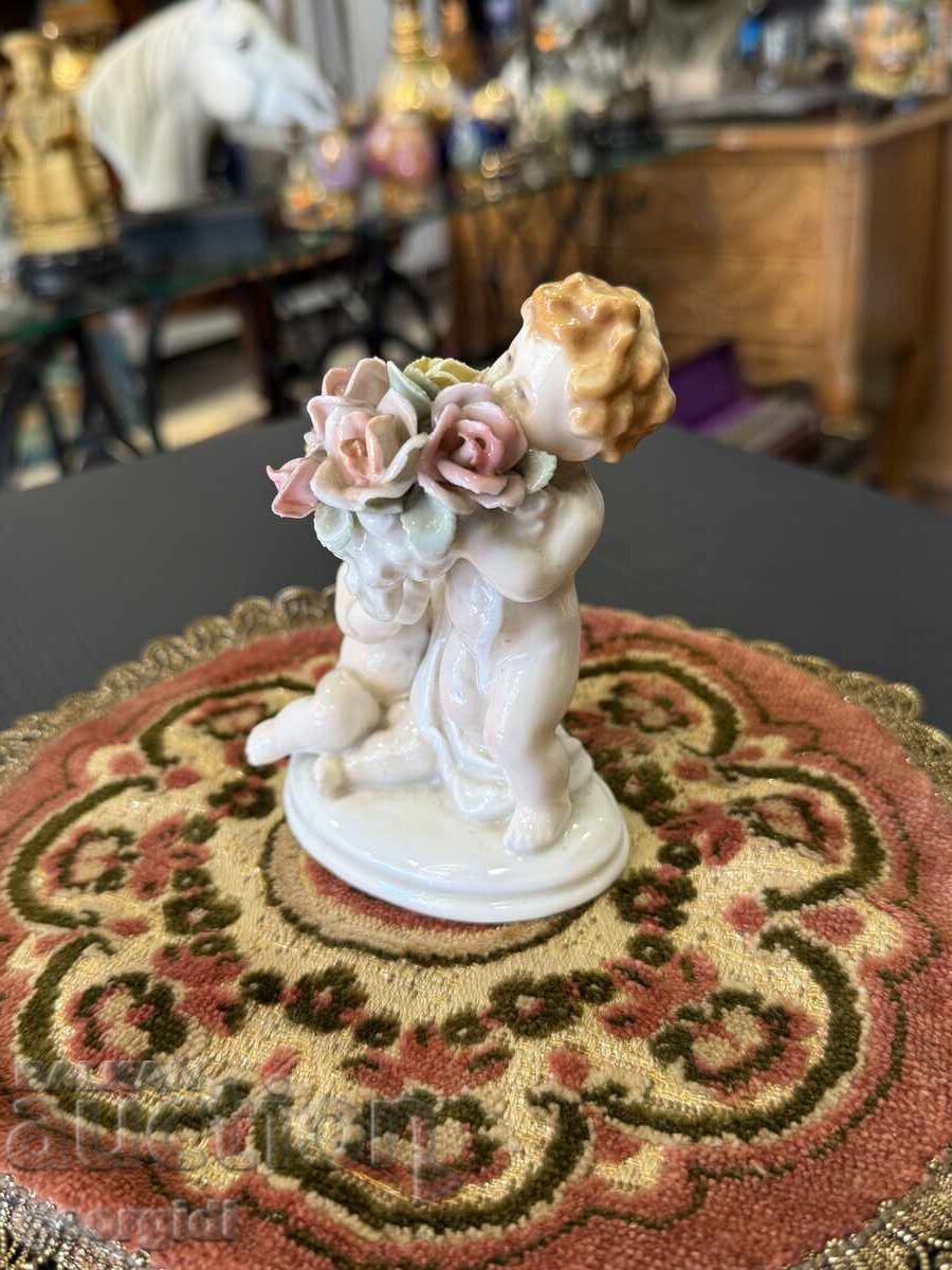 Δημοπρασία Πορσελάνινη φιγούρα ΧΕΡΟΥΒΙΜΙ με μπουκέτο από τριαντάφυλλα Karl Ens. №7906 Δημοπρασία Πορσελάνινη φιγούρα ΧΕΡΟΥΒΙΜΙ με μπουκέτο από τριαντάφυλλα Karl Ens. №7906