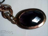 Old silver pendant with a large amethyst stone