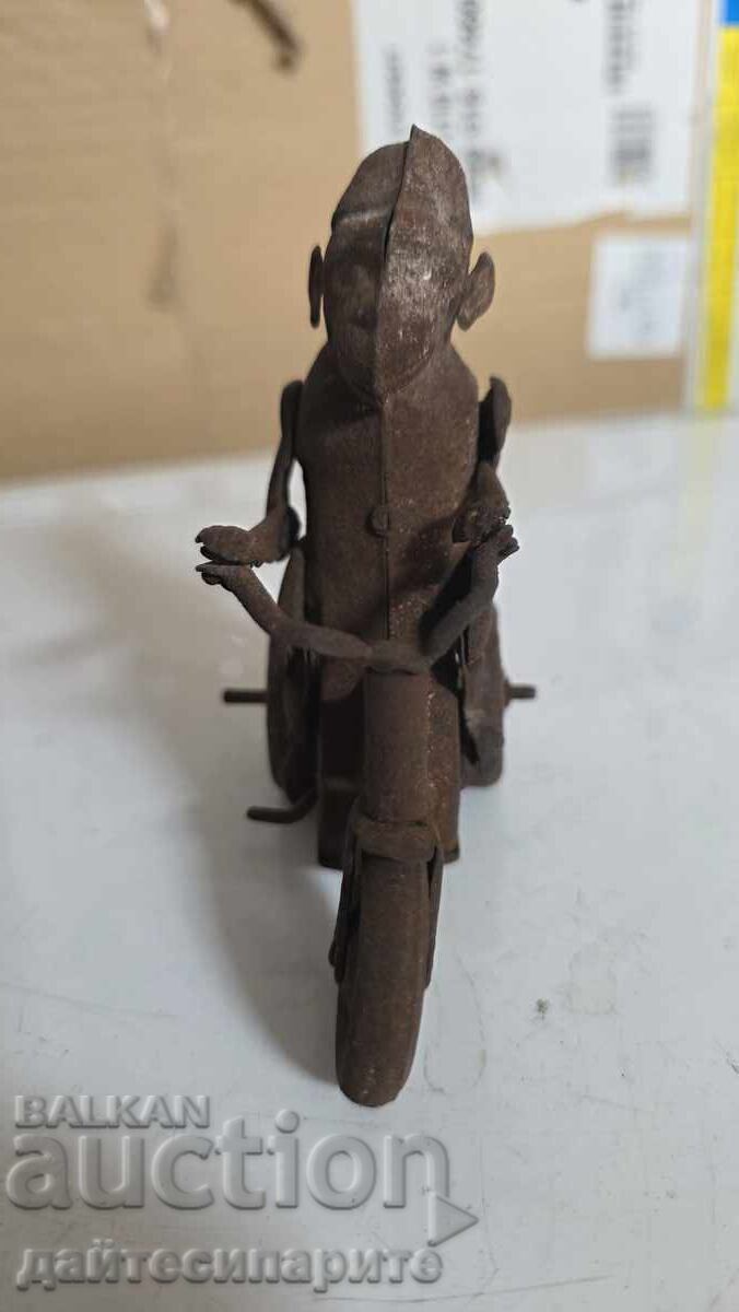Auction  Toy monkey on a wheel, metal, rusty