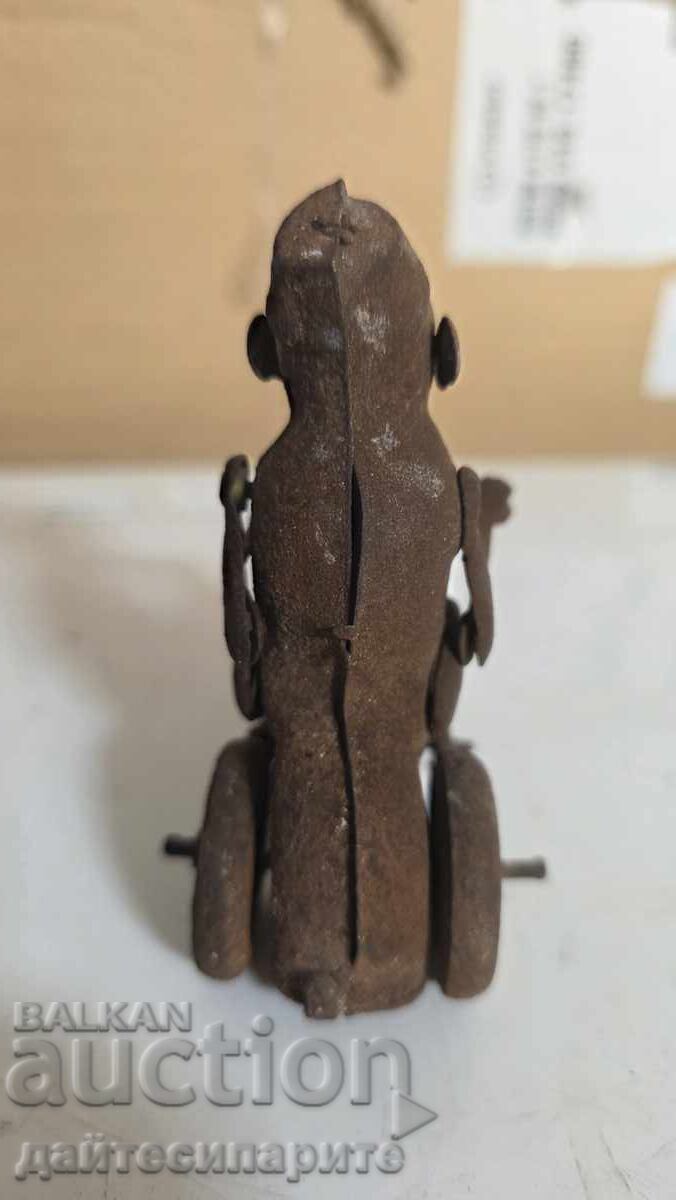 Delivery of Toy monkey on a wheel, metal, rusty