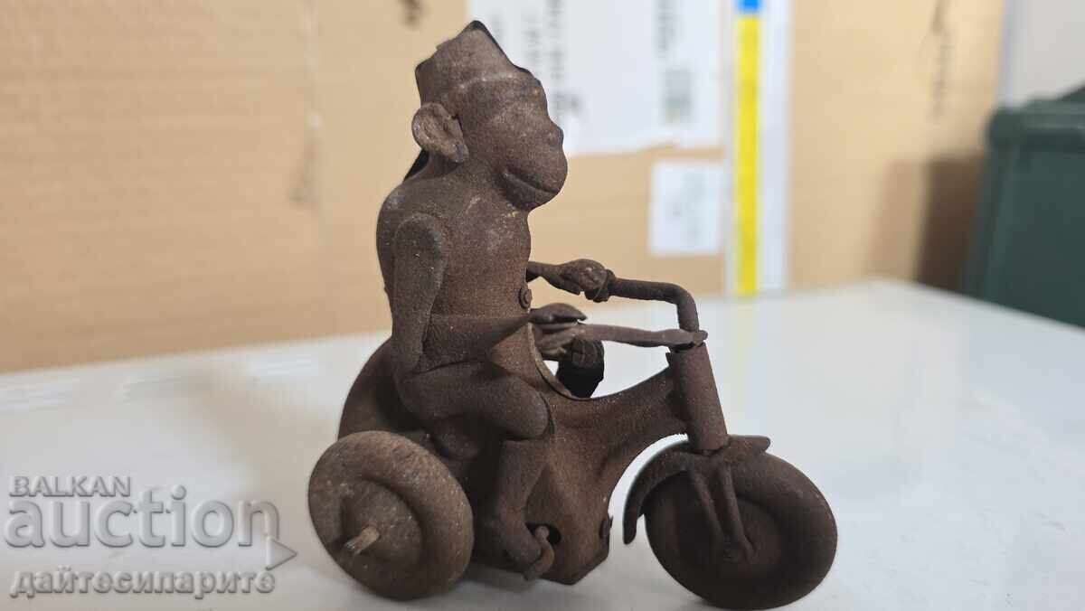 Toy monkey on a wheel, metal, rusty