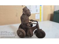 Μεταλλικό παιχνίδι μαϊμού σε ποδήλατο, σκουριασμένο