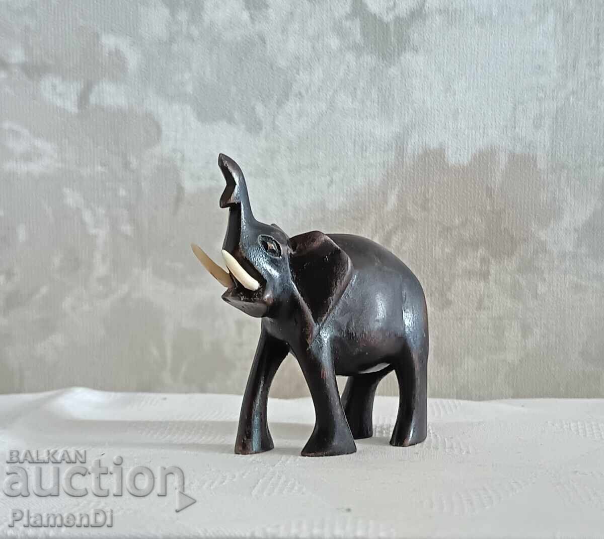 Hand-carved African elephant figurine. Solid wood with price 9.00 €