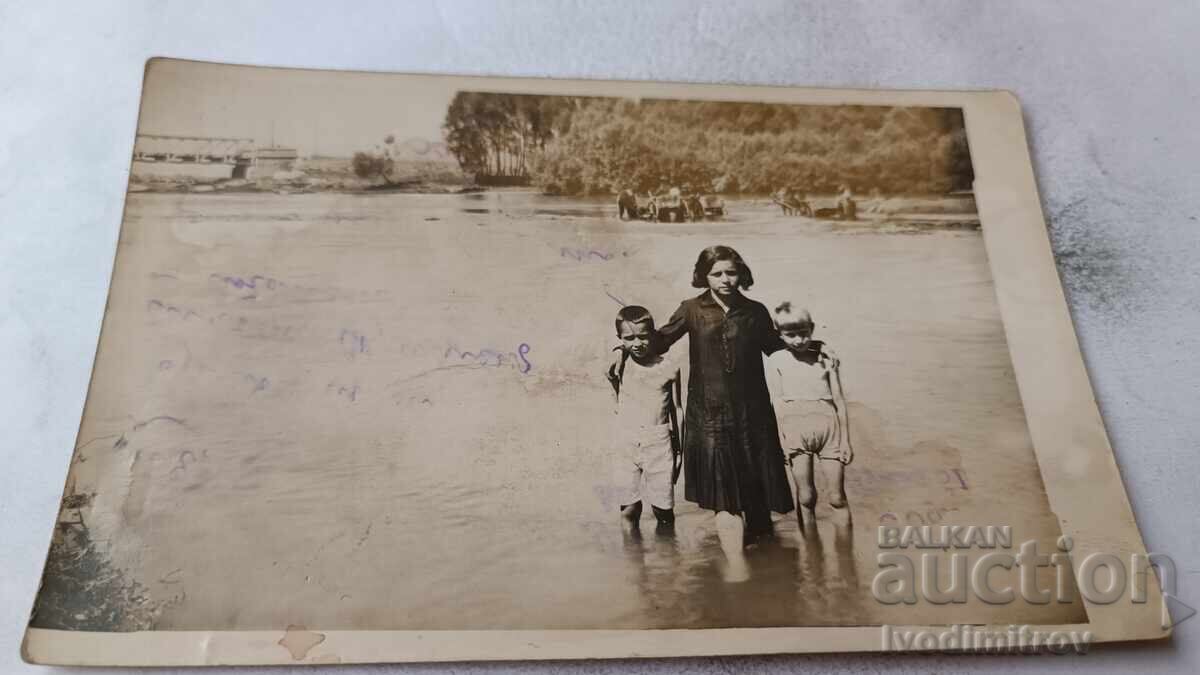 Fotografie Fată și doi băieți într-un râu mare