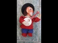 Vintage mechanical clown toy with key