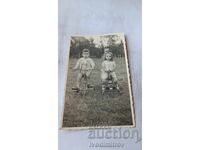 Photo of a little boy and a little girl with retro bicycles