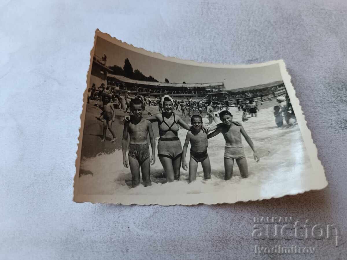 Photo Woman and three boys on the beach