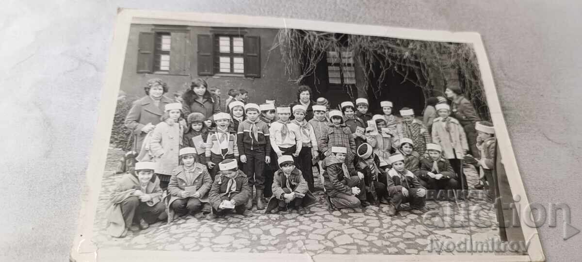 Fotografie cu copii în uniformă de pionieri și cu căciuli de blană