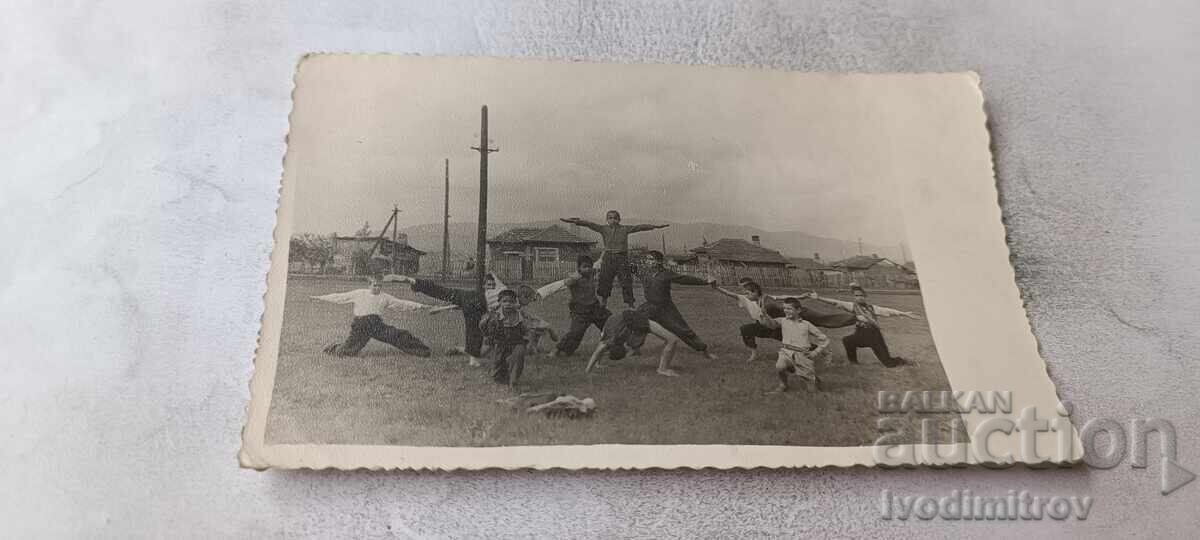 Photo of boys exercising on a meadow