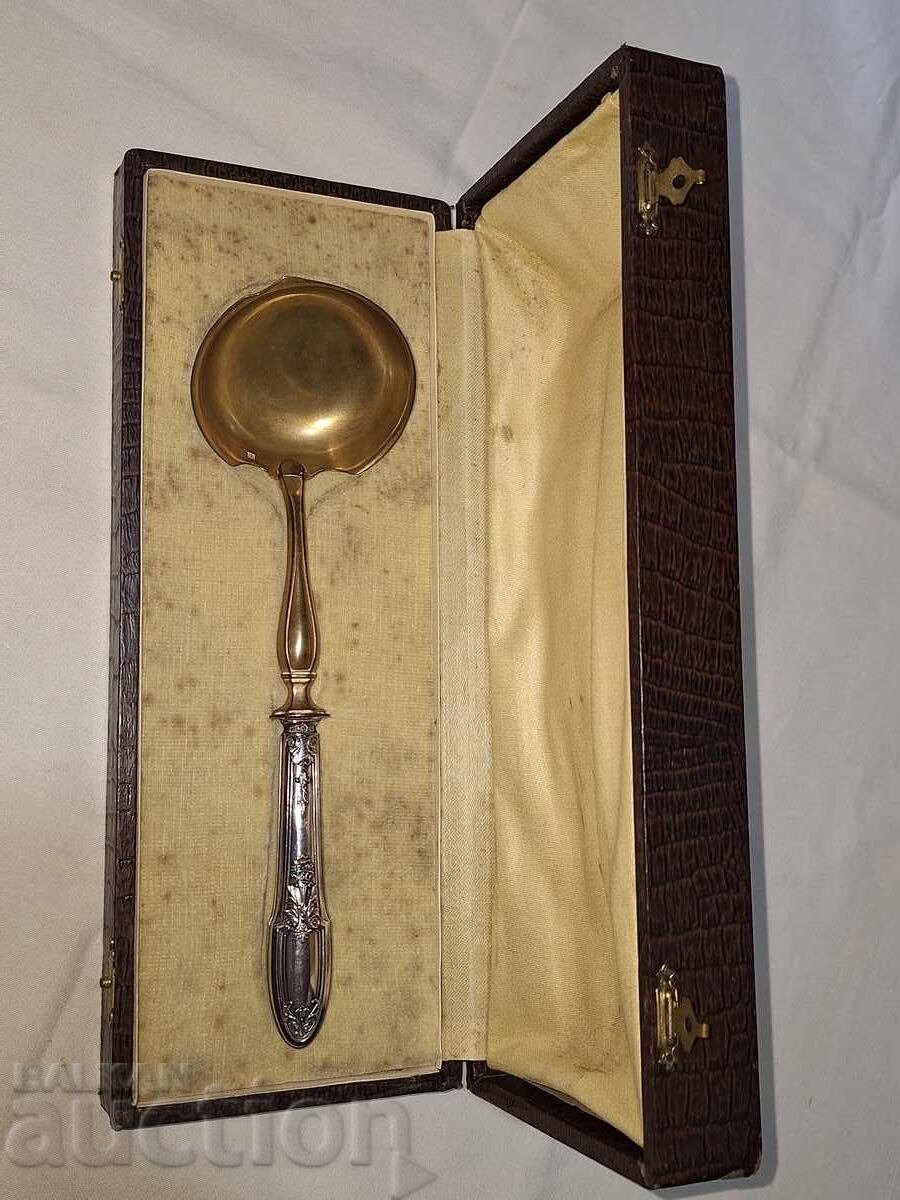 Antique ladle with silver handle and gilding in a box