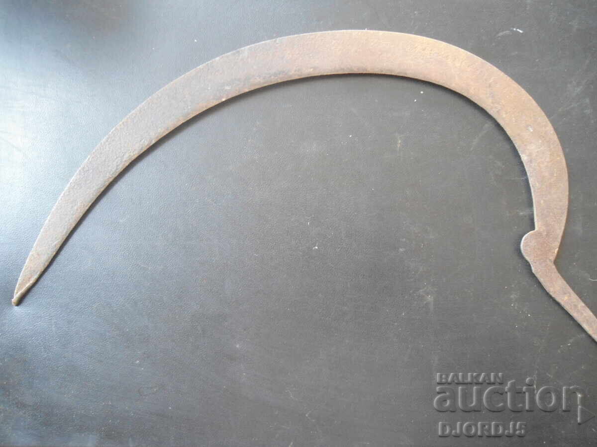Old forged sickle, engraved