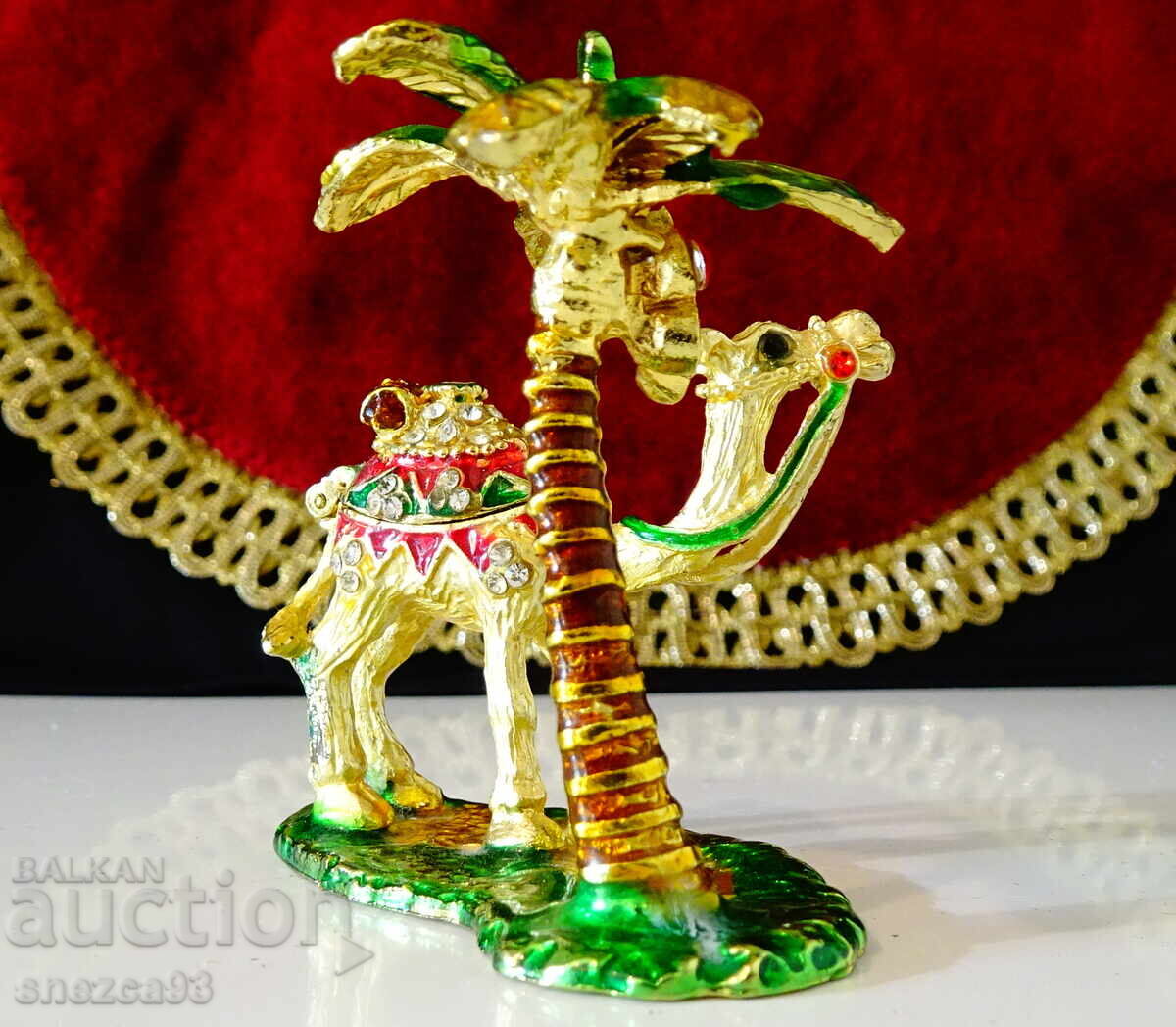 Auction Gold-plated box, camel figurine, palm tree, crystals Auction Gold-plated box, camel figurine, palm tree, crystals
