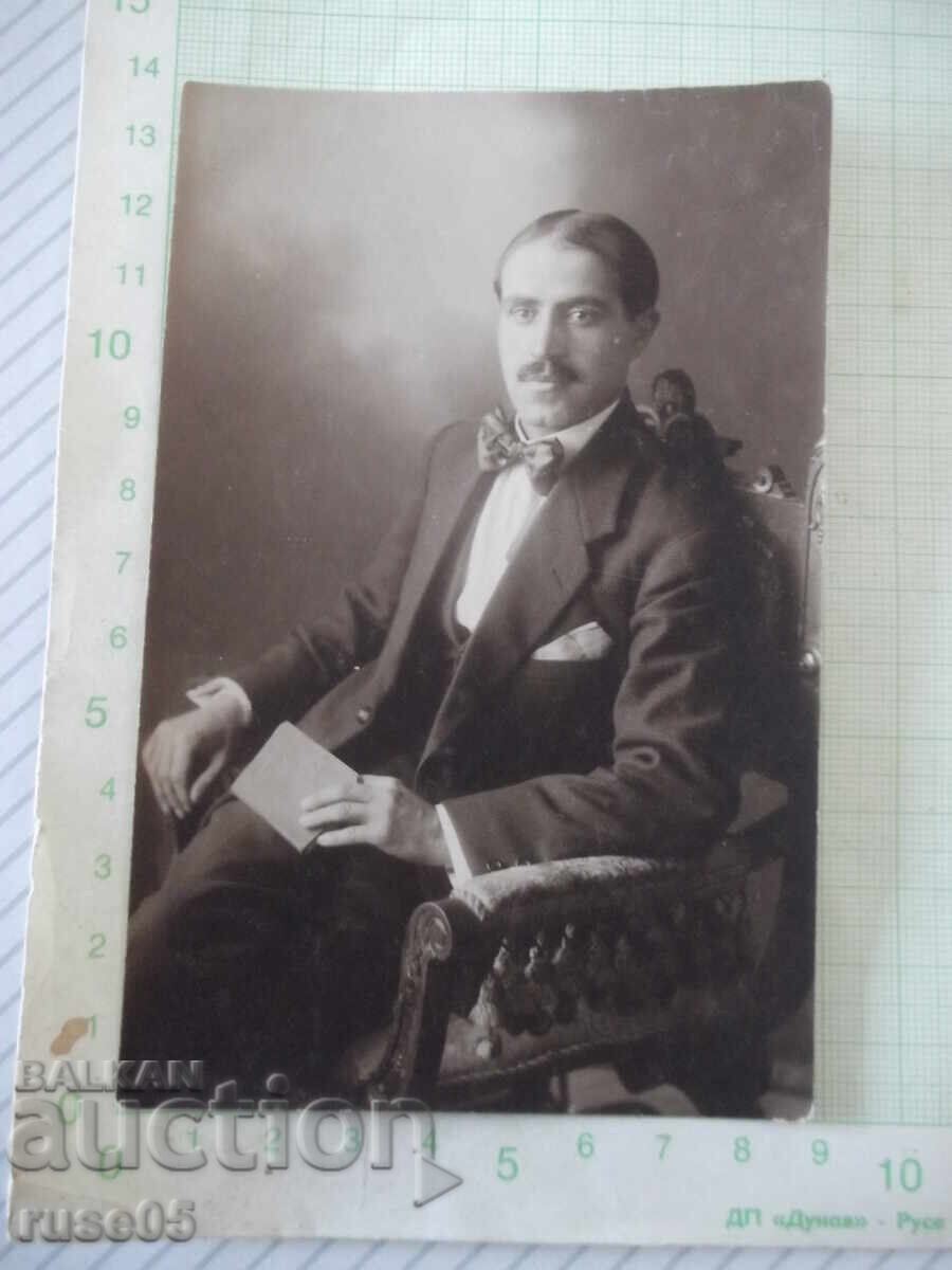 Old photo of a gentleman sitting in an armchair