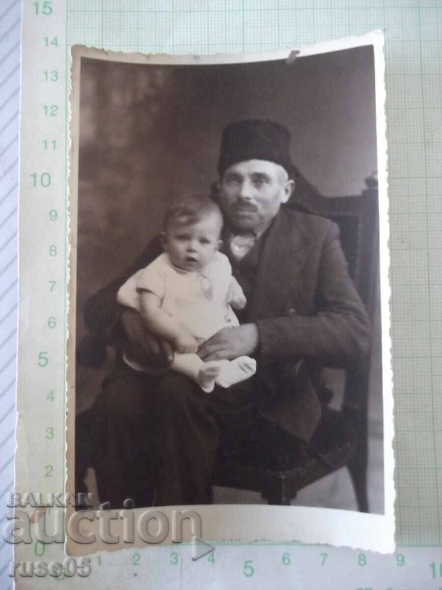 Old photo of a grandfather with a grandchild